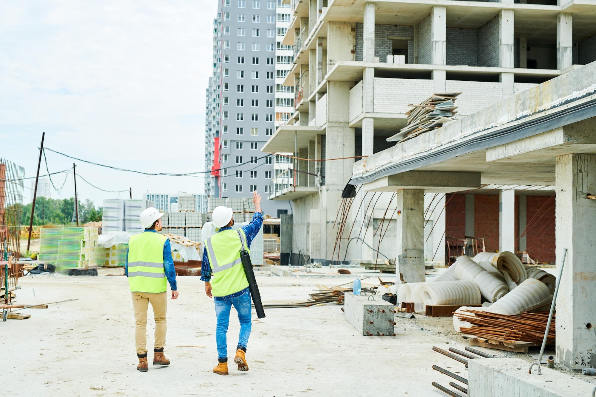 construction workers using temperature data loggers to monitor relative humidity and temperature at a job site